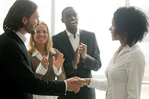 Woman employee being recognized by peers